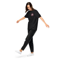 Thumbnail for Woman wearing a black t-shirt with a logo and black jeans on a white background