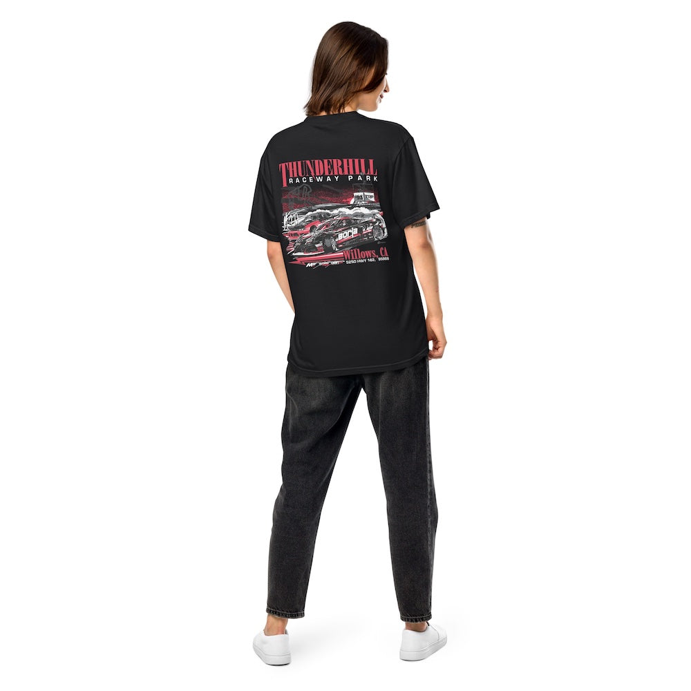 Person wearing a black t-shirt with a graphic design on the back, standing against a white background
