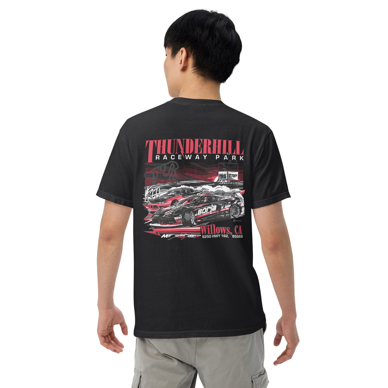 Person wearing a black t-shirt with a graphic design on the back, featuring the text 'Thunderhill Raceway Park' and race car illustration.
