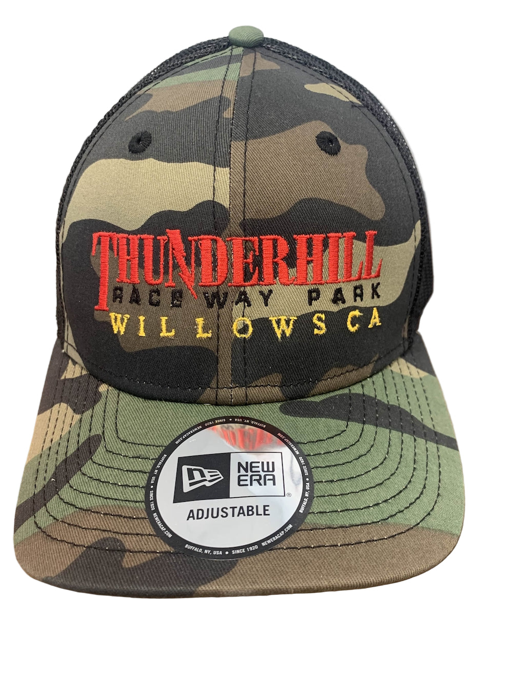 Camouflage cap with 'Thunderhill Raceway Park' text on a wooden surface