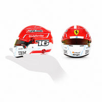 Thumbnail for Charles Leclerc 2026 F1 mini helmet scale comparison showing side and front views on white background